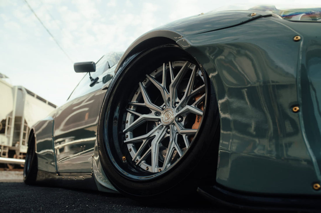 Close-up of a multi-spoke aftermarket wheel fitted to a lowered car